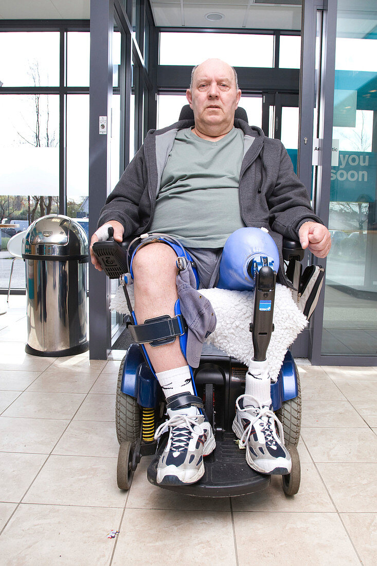 Male wheelchair going through an automatic door