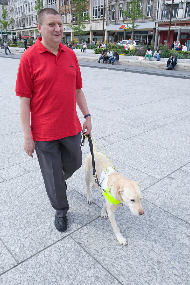 Vision impaired man with guide dog
