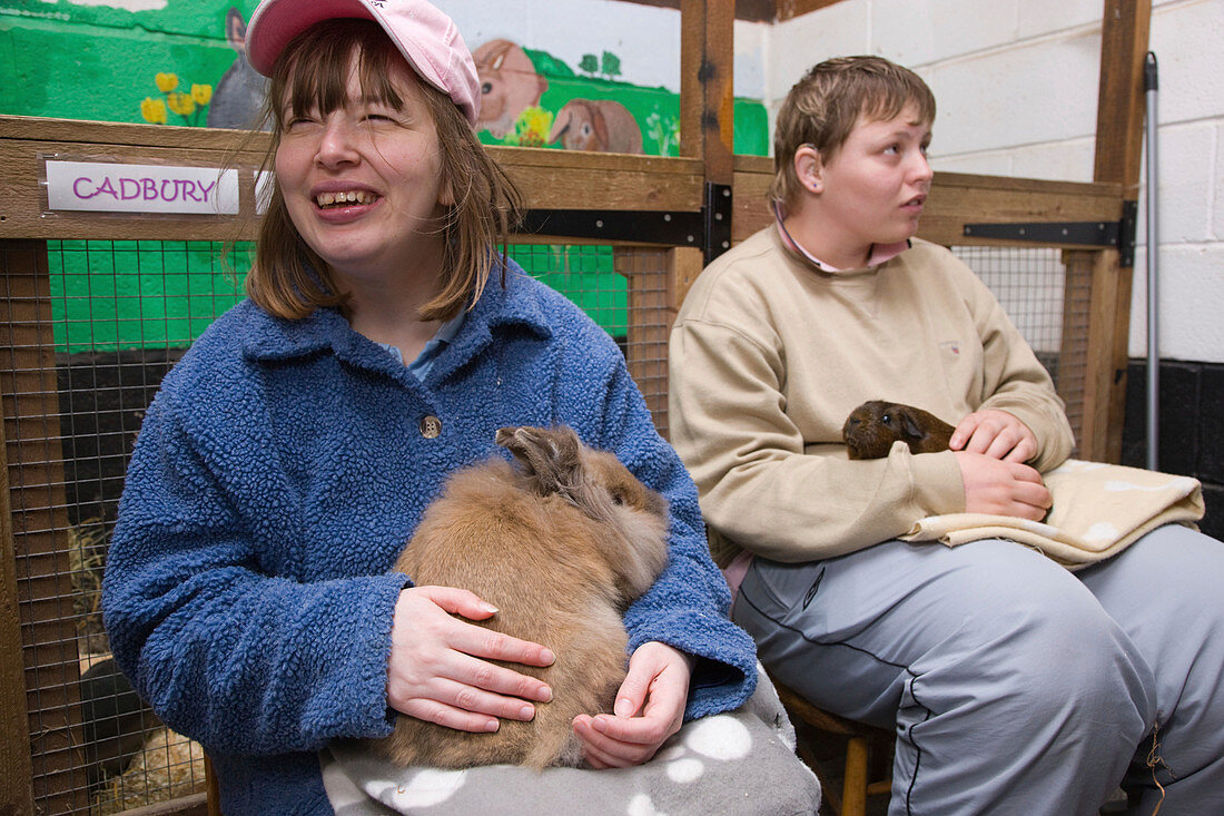 Young women with learning disabilities at petting zoo