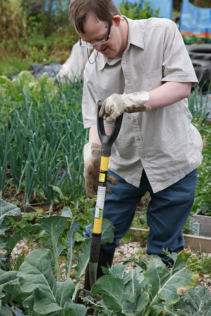 Man with learning disability working on allotment