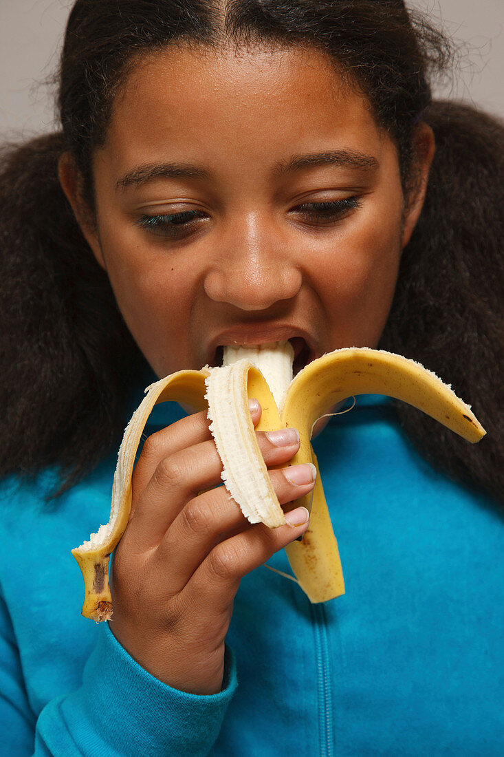 Portrait of girl eating fruit