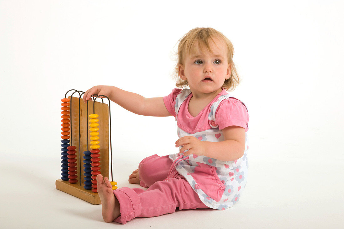Little girl playing with an abacus