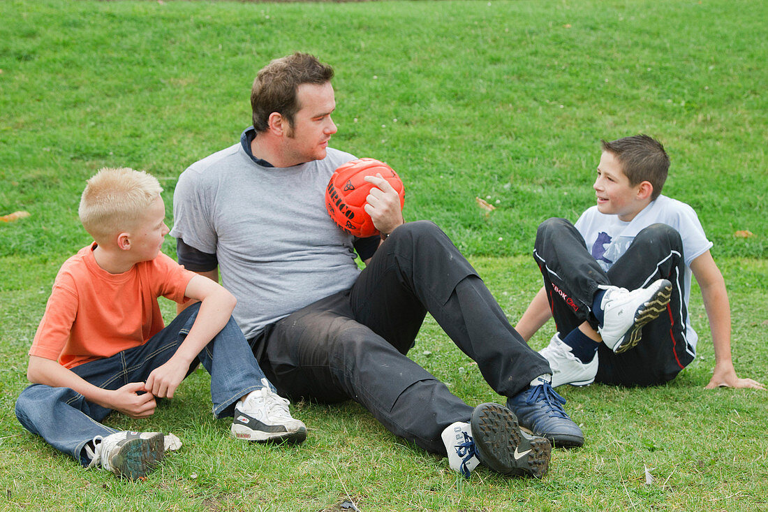 Man and boys with football