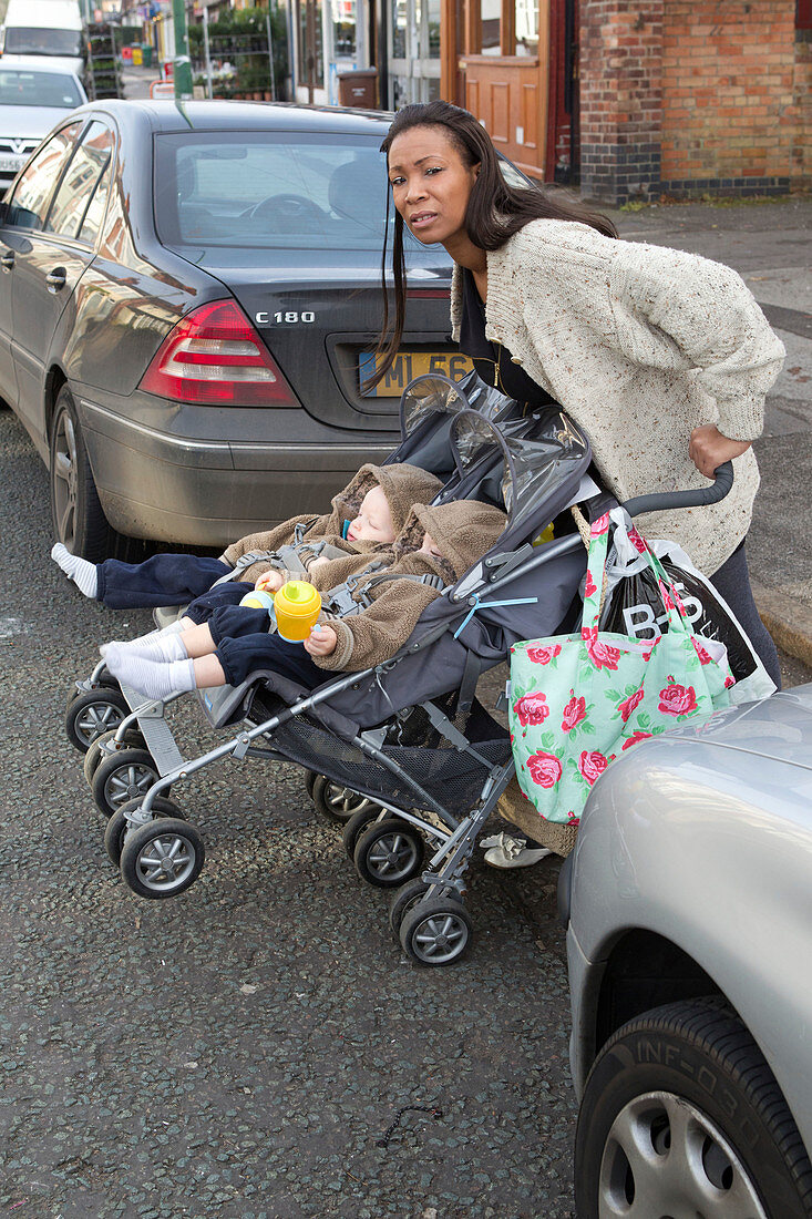 Mother with twins in buggy trying to cross road