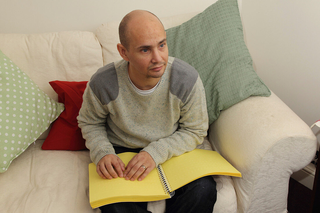 Man reading a braille document