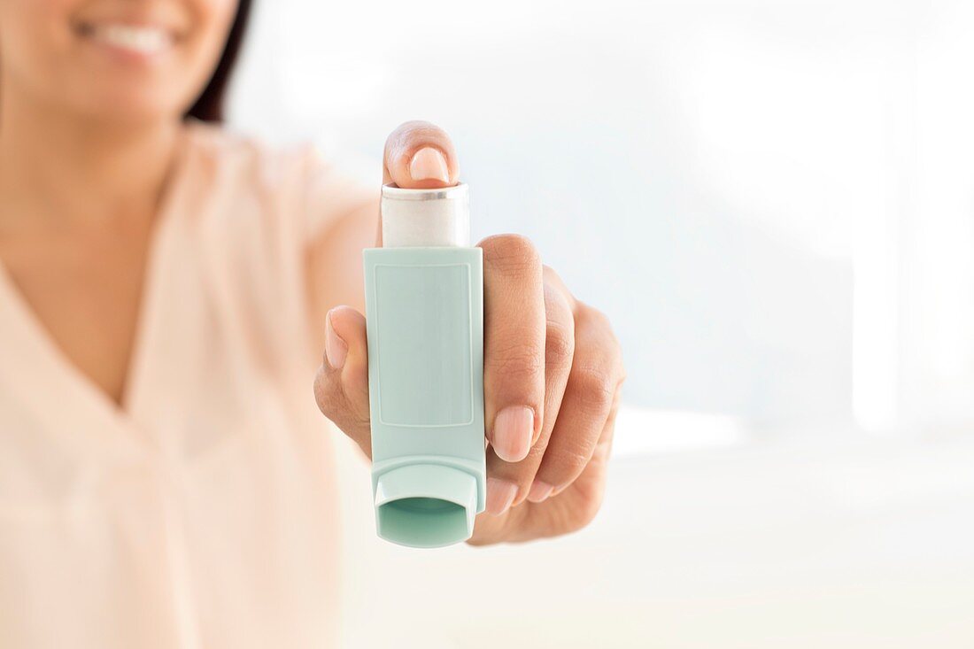 Woman holding inhaler