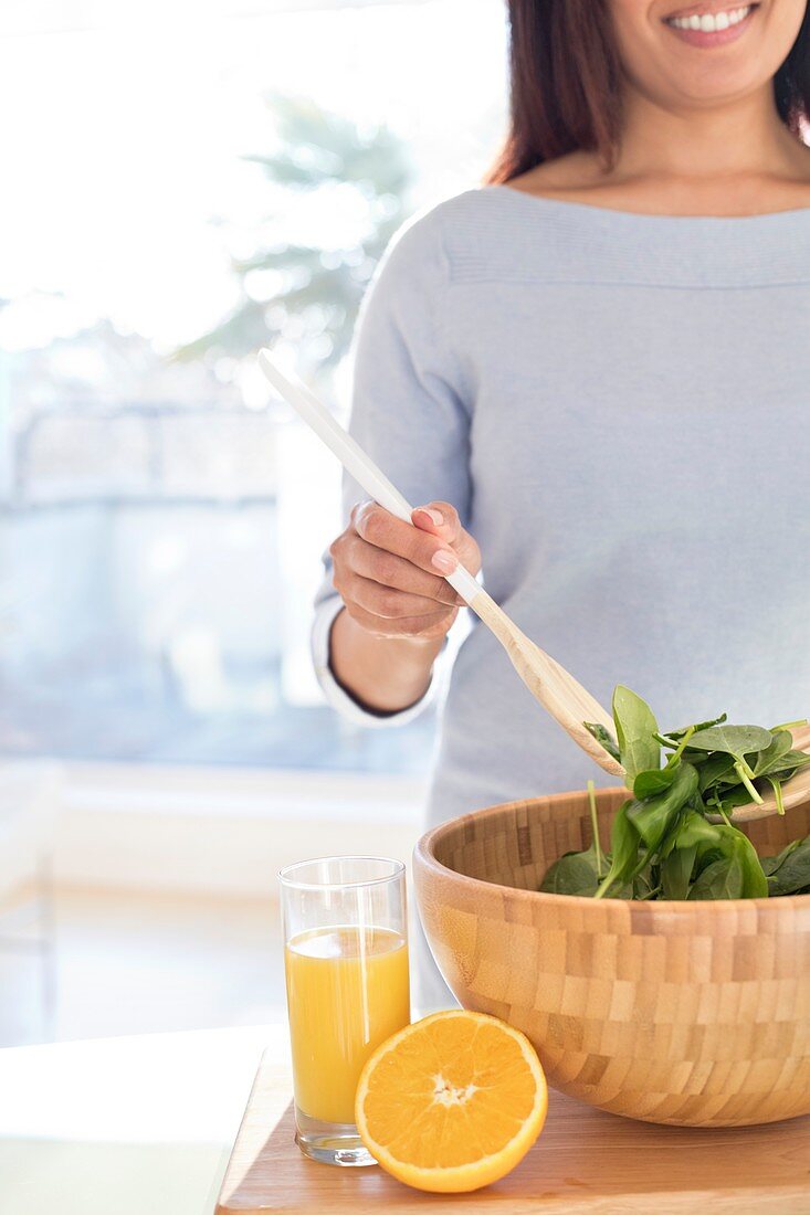 Woman making fresh salad