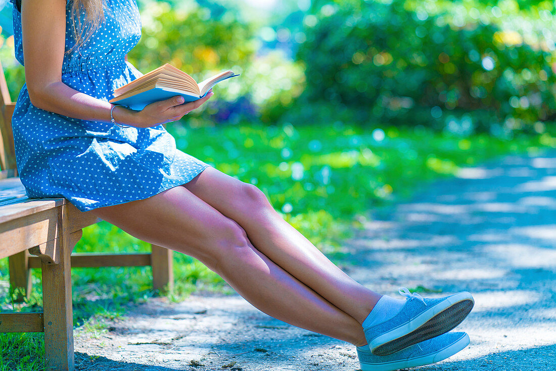 Close-up of a woman reading in a park