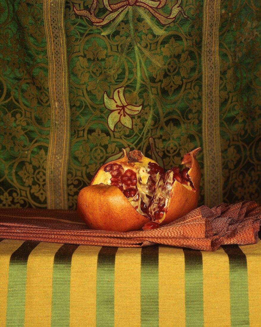 Pomegranate Broken Open; Resting on a Cloth