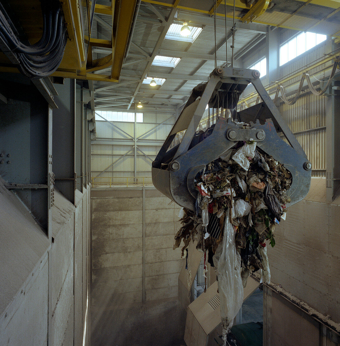 Waste ready for incineration in giant crane grab jaws, 1980