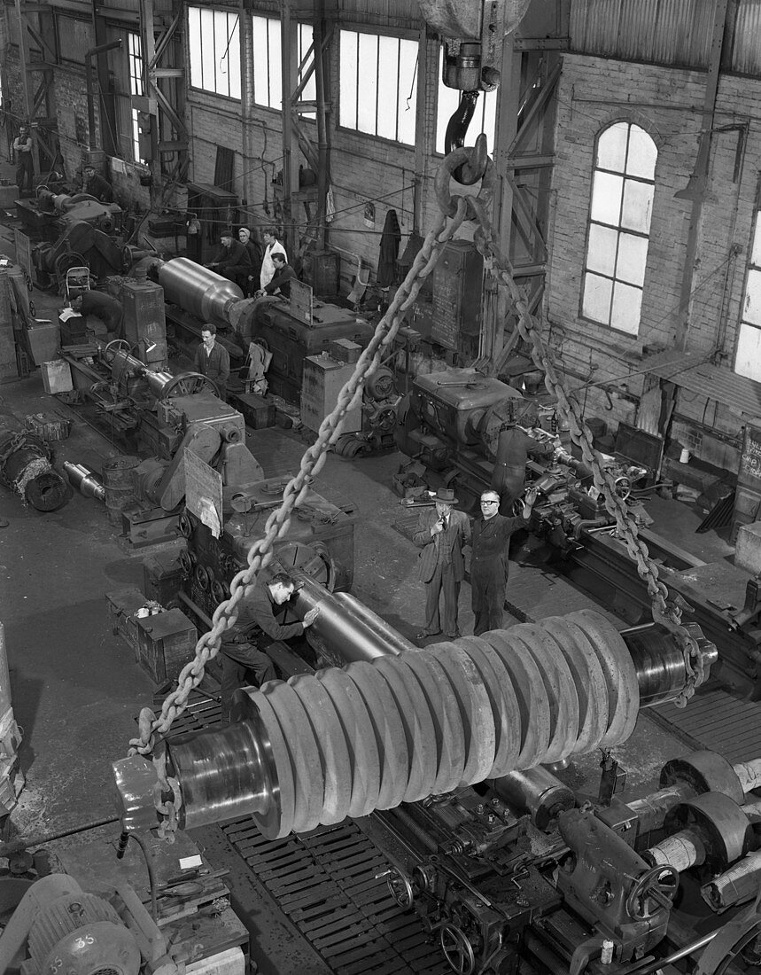 A busy foundry shop floor with lathes, 1963