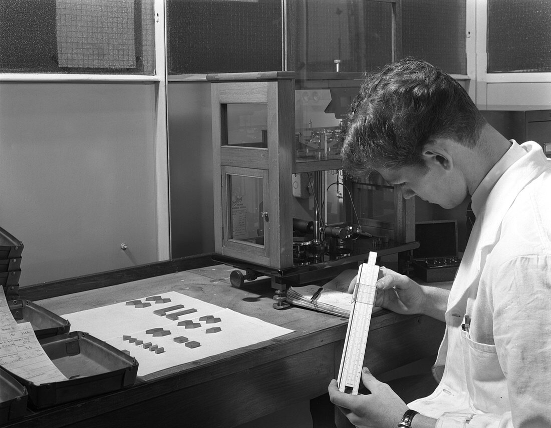Lab technician with a slide rule, 1962