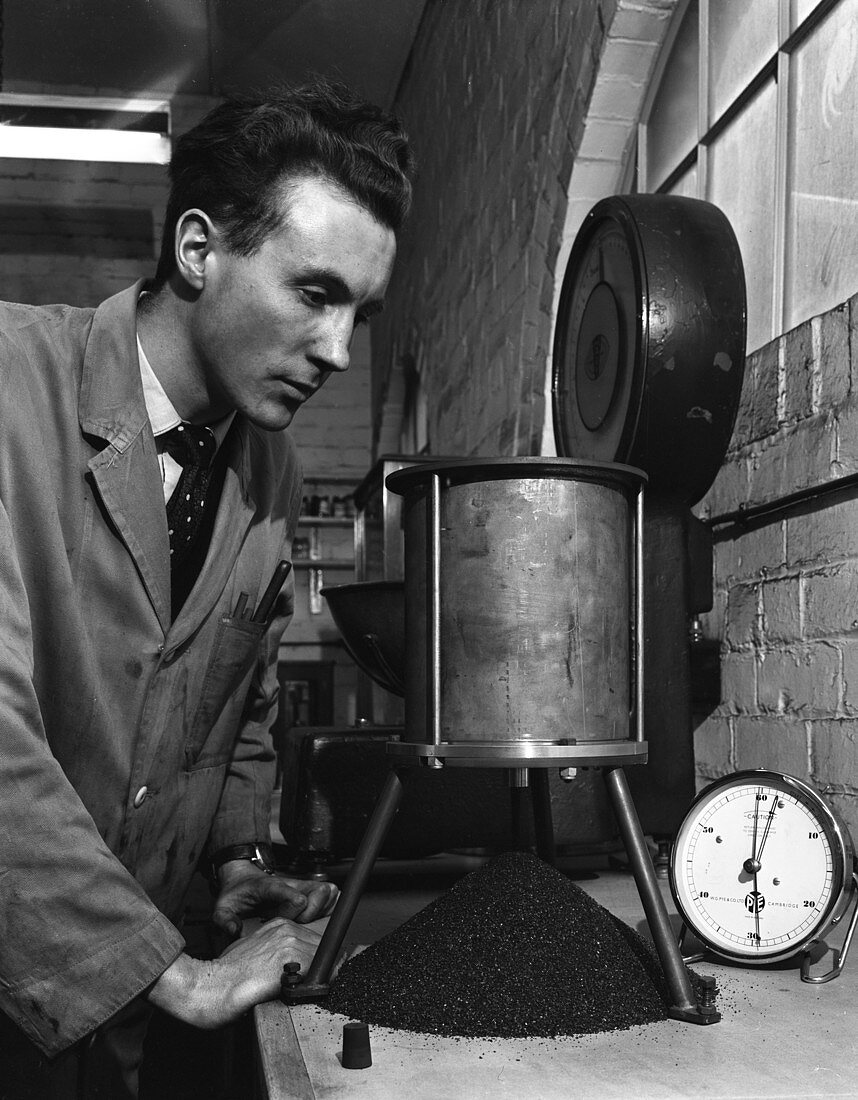 A lab technician undertaking a coal flow test, 1962