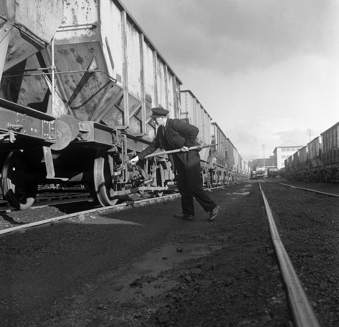 Final adjustments to a rail truck hauling coal, 1963