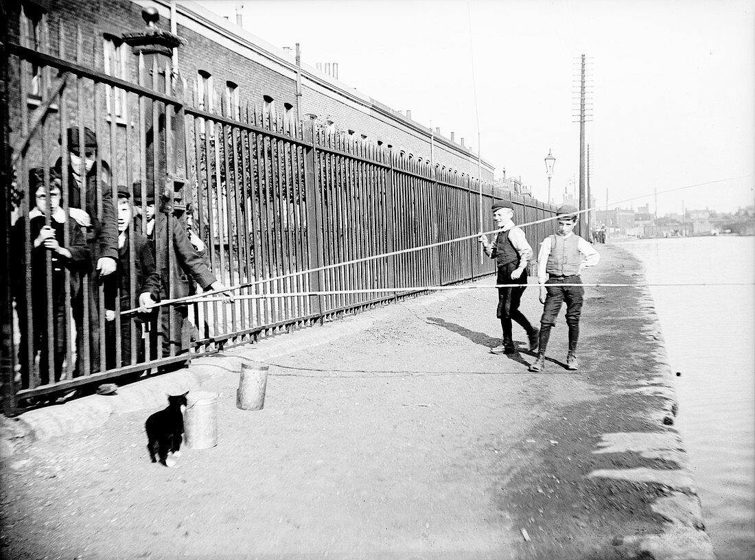 Boys fishing across a canal towpath, London, c1905