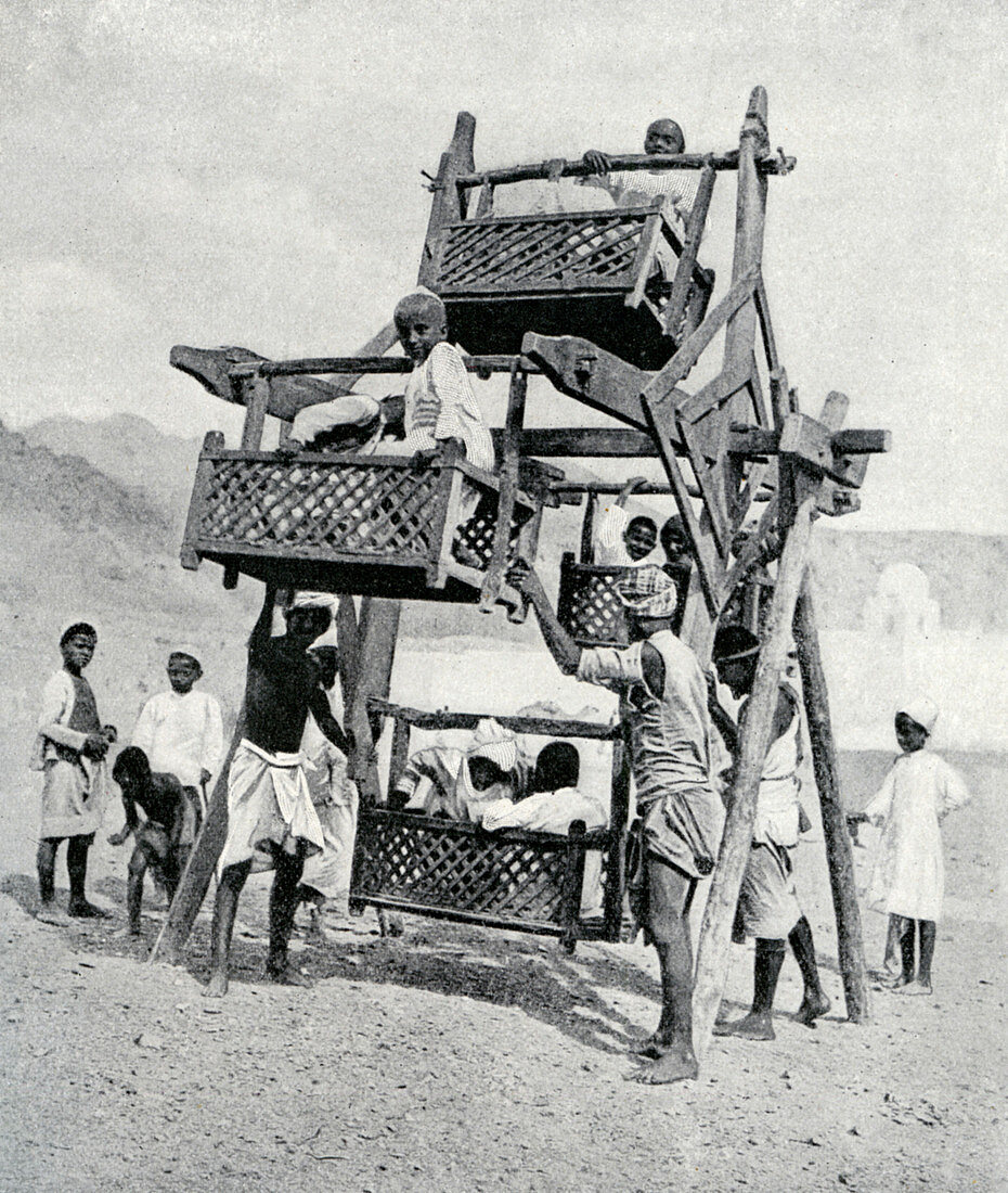 Arabian children enjoying a 'big-wheel', 1922