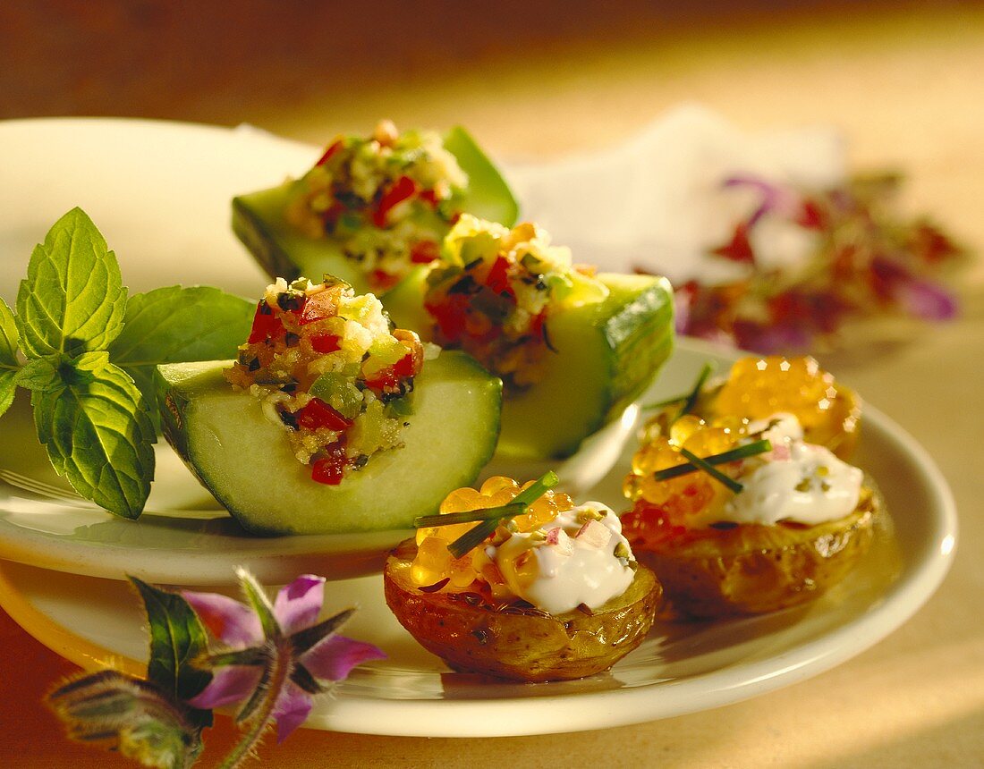 Potatoes with caviare and filled cucumber boats