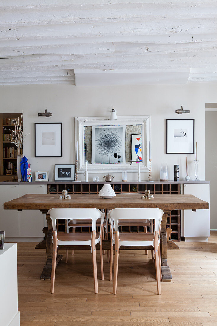 Modern chairs around rustic wooden table in dining room