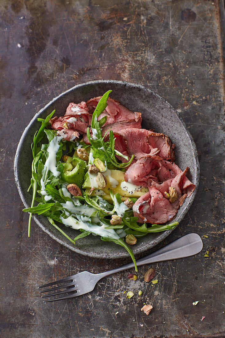 Rocket and roast beef salad with avocado and pistachio nuts
