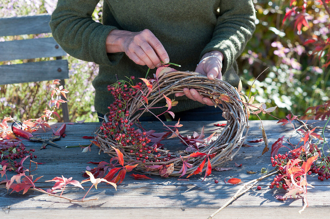 Autumn wreath with rose hips and wild wine