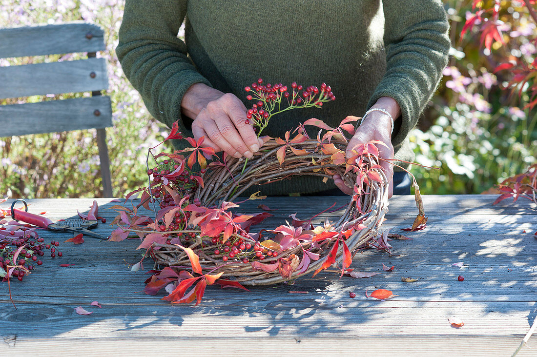 Autumn wreath with rose hips and wild wine