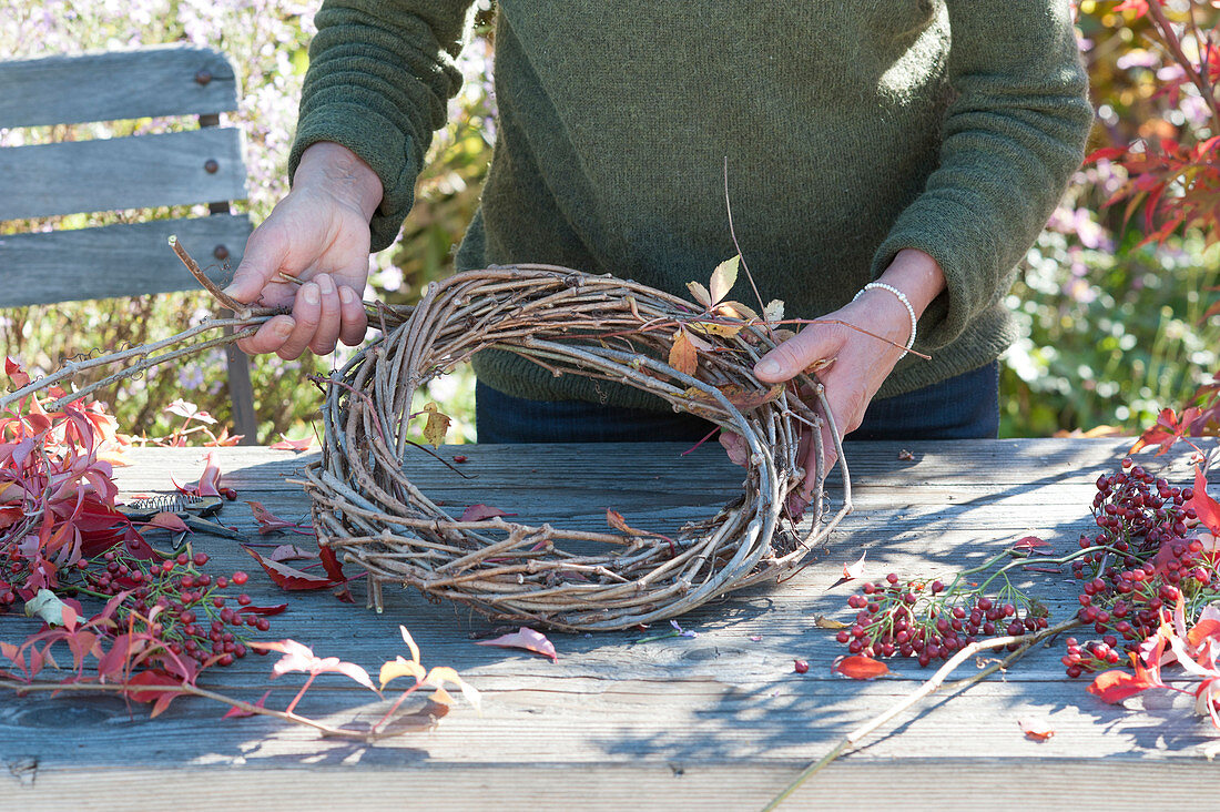 Autumn wreath with rose hips and wild wine