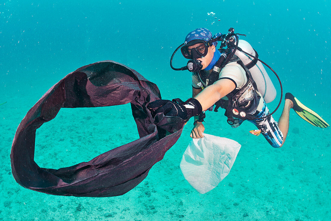 Scuba diver collecting plastic waste