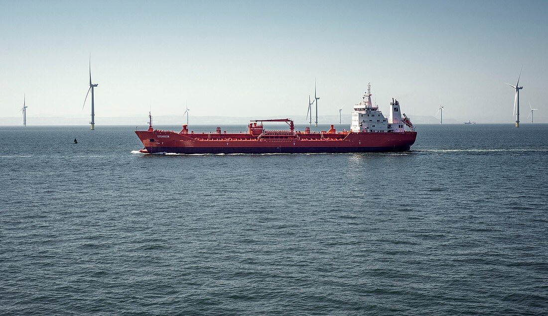 Oil tanker passing offshore windfarm