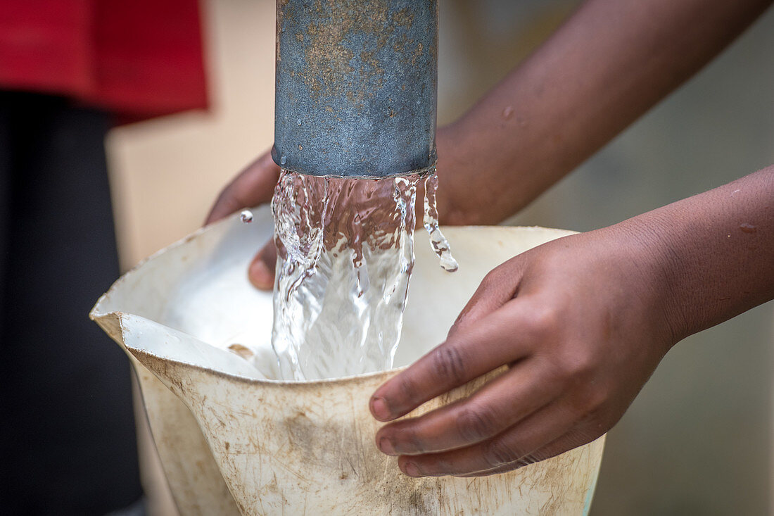 Collecting water from a pump, Ganta, Liberia