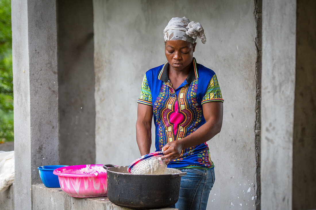Woman preparing Cassava based Fufu dough, Ganta, Liberia