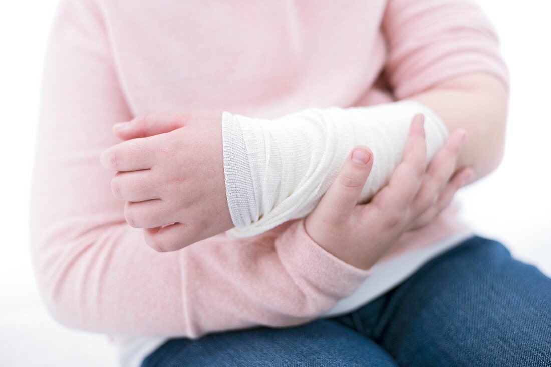Girl with bandaged arm