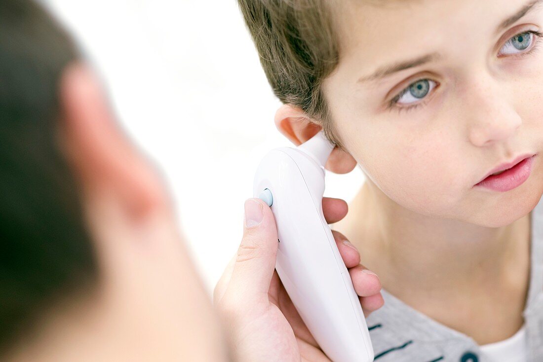 Boy having his temperature taken