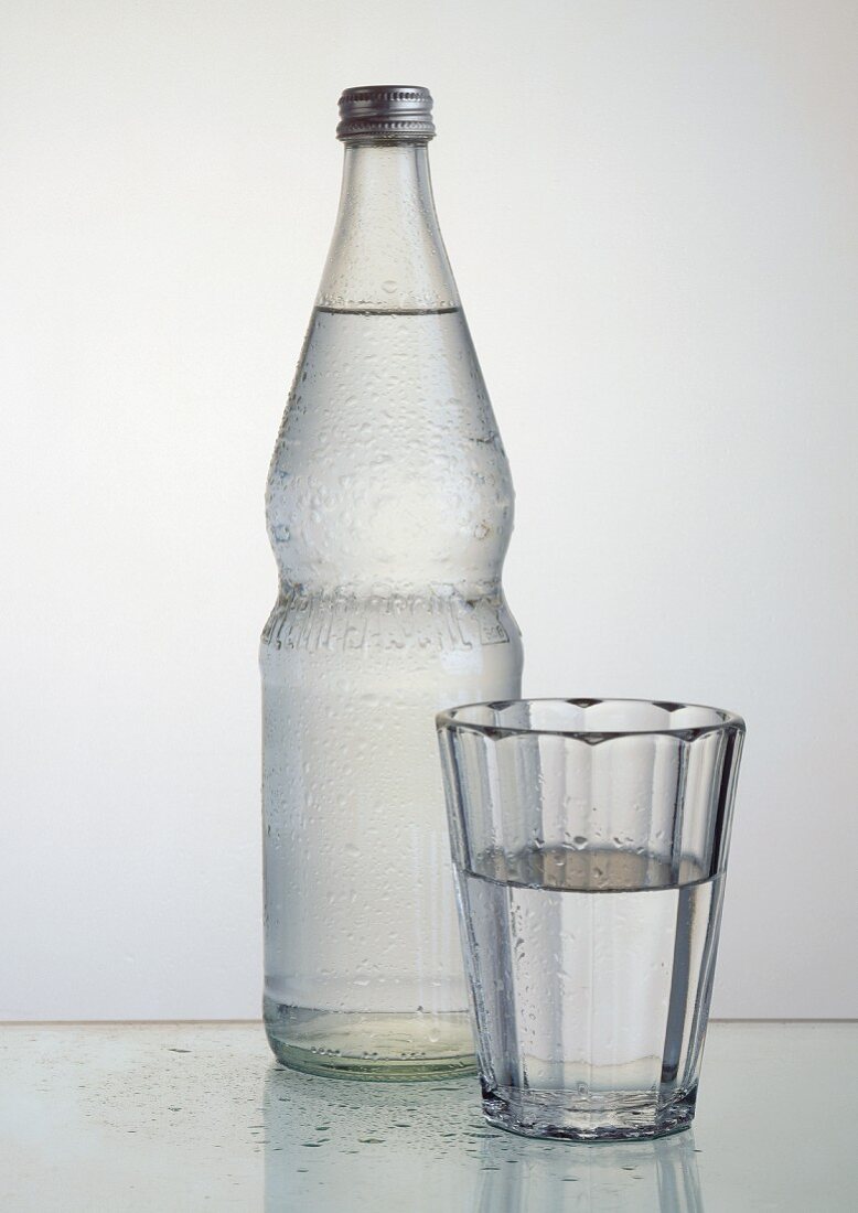 Mineral water in glass and bottle