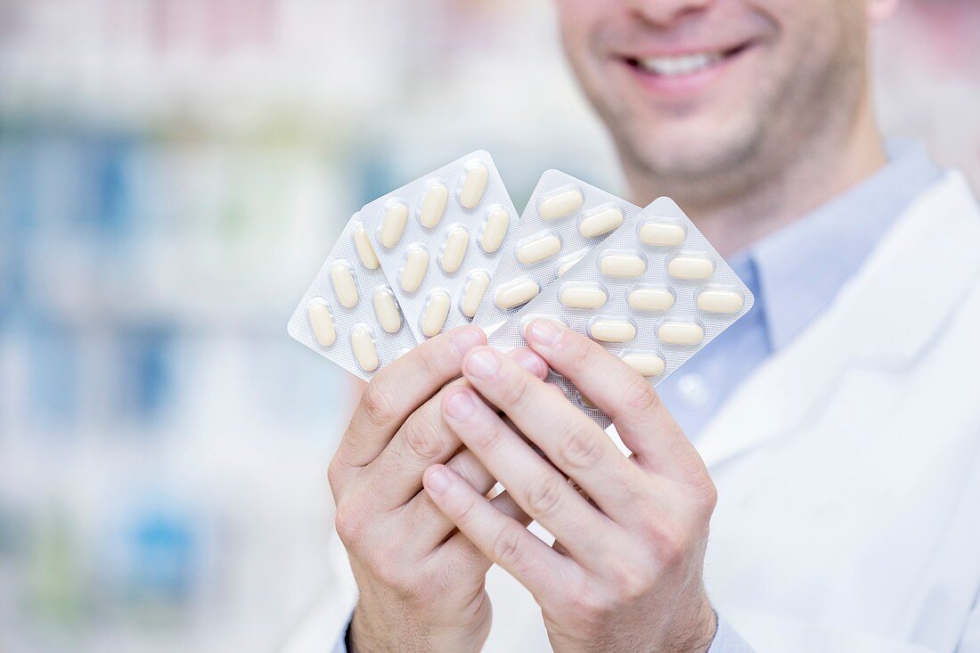 Pharmacist holding blister packs