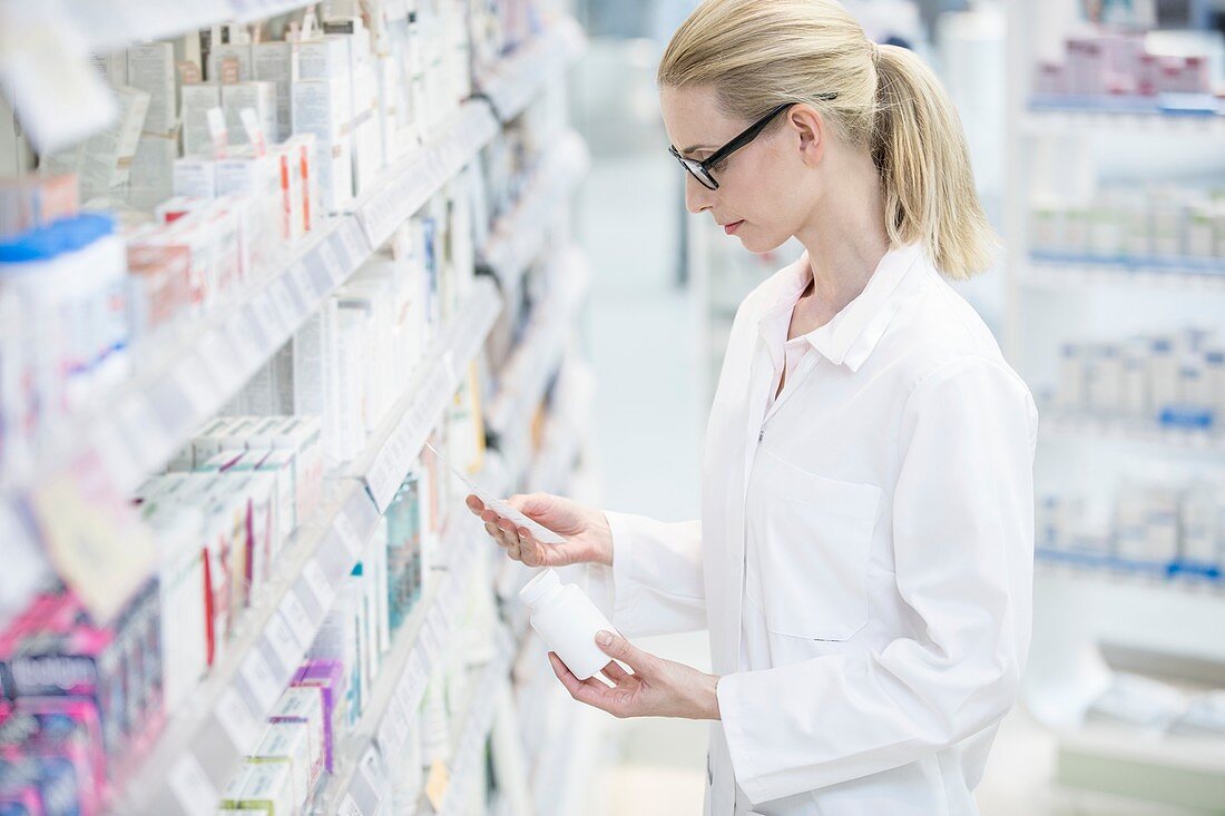 Pharmacist reading prescription