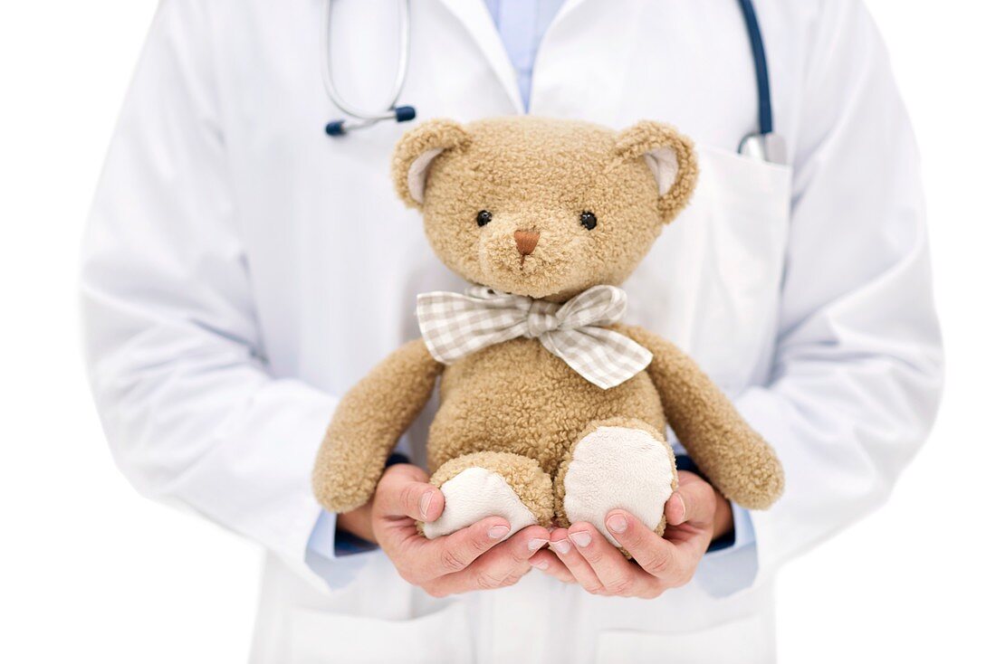 Doctor holding teddy bear