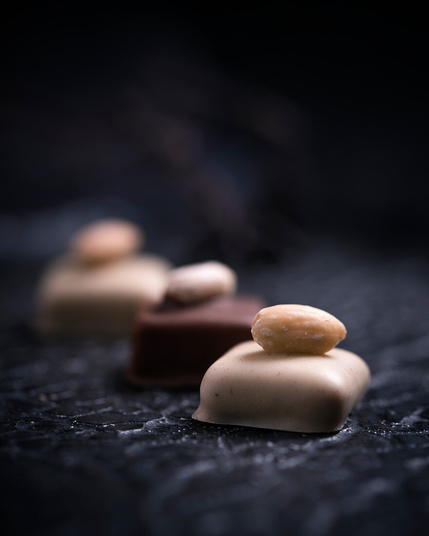 Vegan almond pralines, covered with light and dark rice milk chocolate