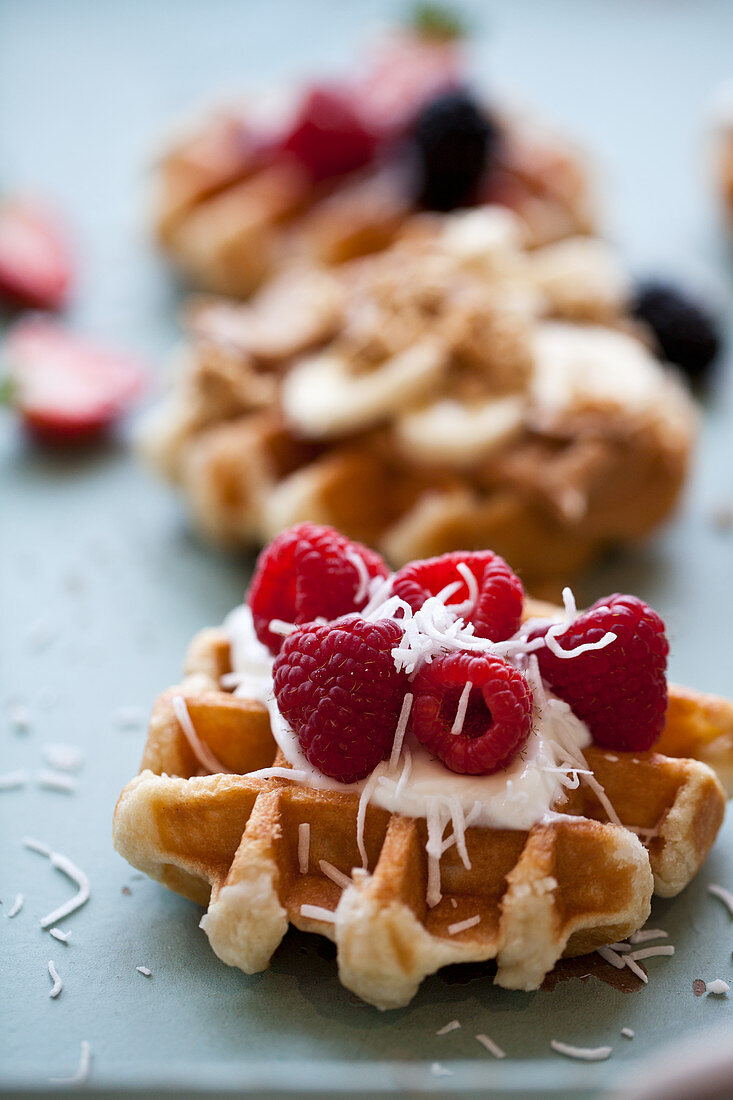 Waffled topped with raspberries, vanilla yogurt and coconut