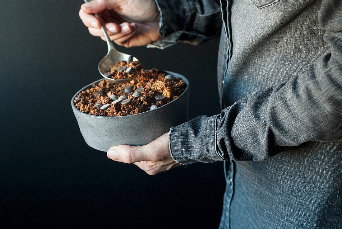 Man eating crunchy quinoa granola