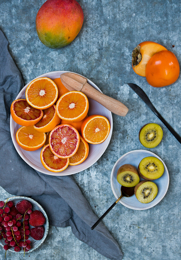 Fresh fruits: blood oranges, mango, persimmons, kiwis and iced berries