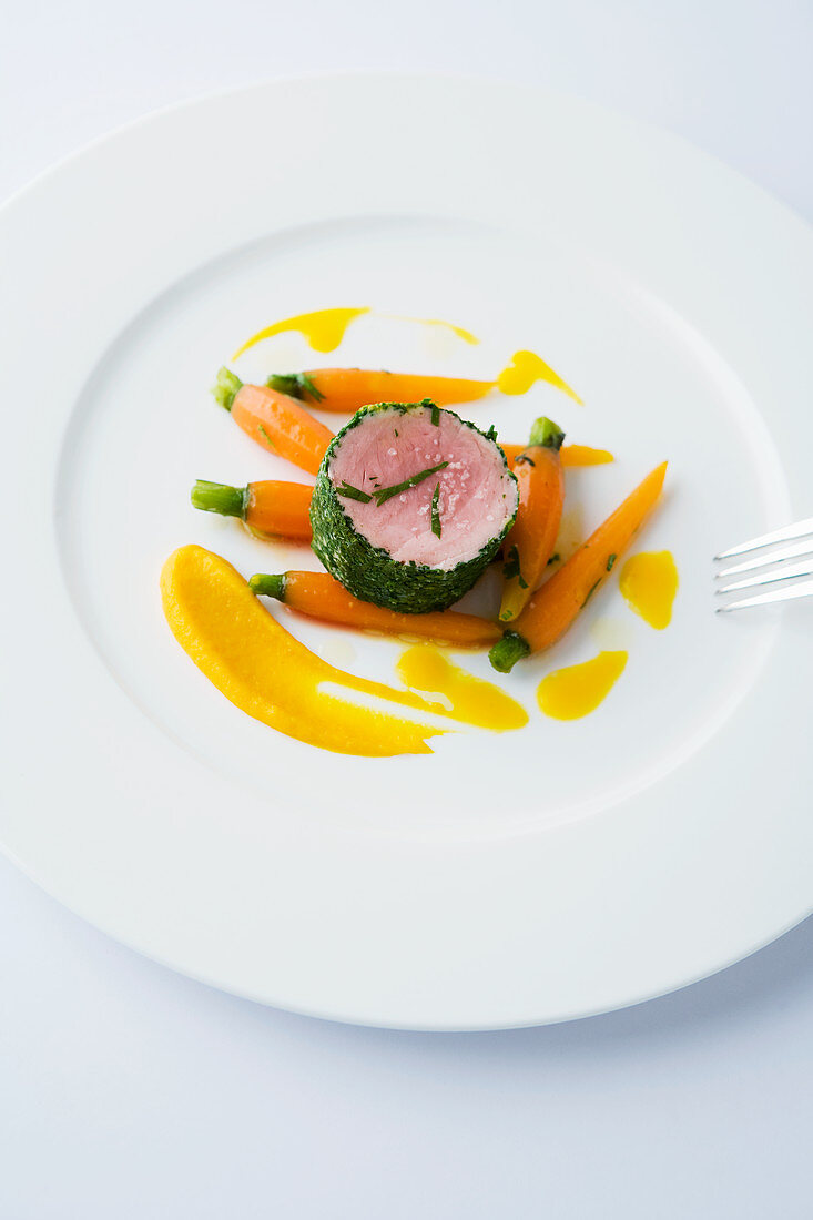 Poached pork fillet in a herb coat with carrots