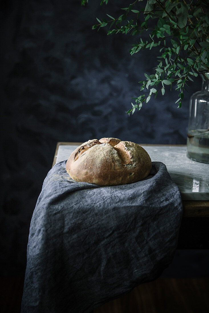 A loaf of olive bread on a linen cloth