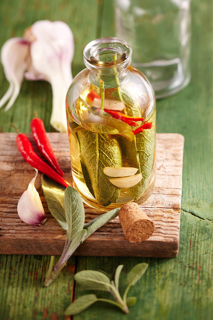 Homemade sage oil with red chilli and garlic