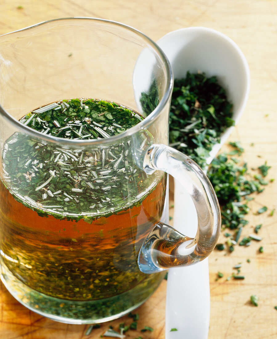 Homemade herb vinegar with fresh rosemary, parsley and wine vinegar