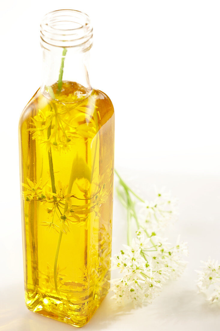 Homemade wild garlic flower oil in a bottle
