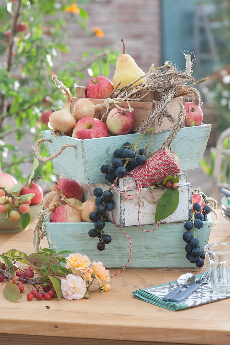 Thanksgiving decoration with fruit and ears in wooden boxes