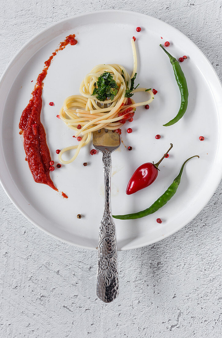 Spaghetti with tomato pesto and sauce on white background