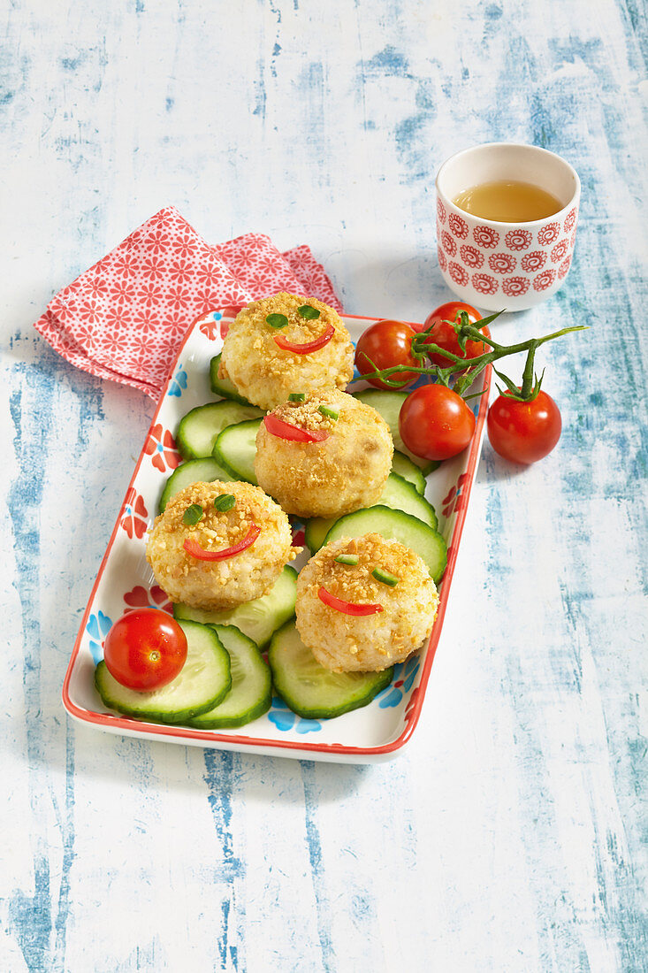 Stuffed rice balls with vegetable faces