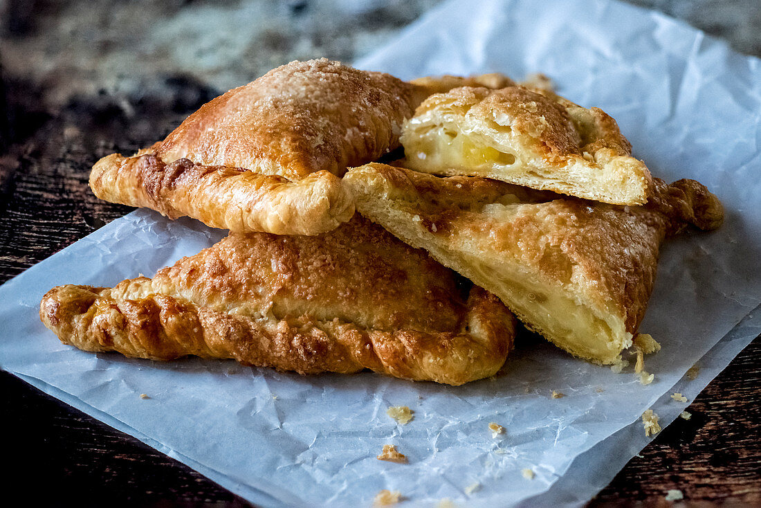 Crunchy flaky pastry placed on paper napkin on wooden table