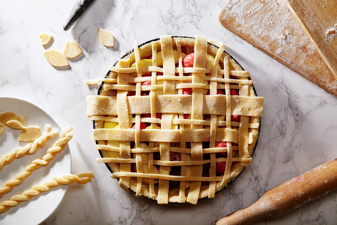 Uncooked pie with berries and apples